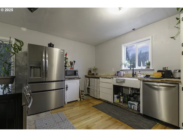 a kitchen with a refrigerator and a sink