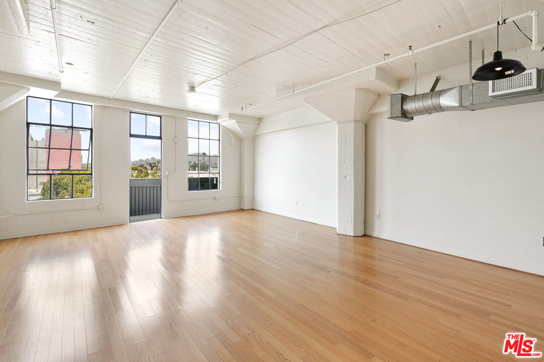 200 North San Fernando Road, Unit 320 Los Angeles, CA 90031 - Photo 11 of 20 a view of a room with wooden floors and kitchen view