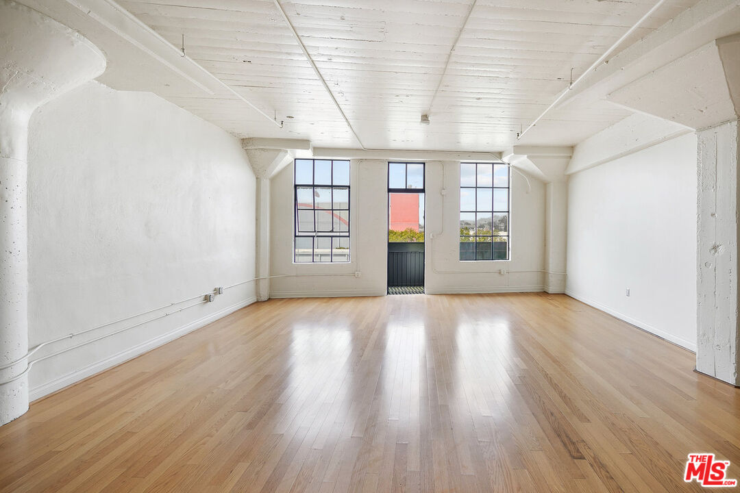 200 North San Fernando Road, Unit 320 Los Angeles, CA 90031 - Photo 12 of 20 an empty room with wooden floor and windows