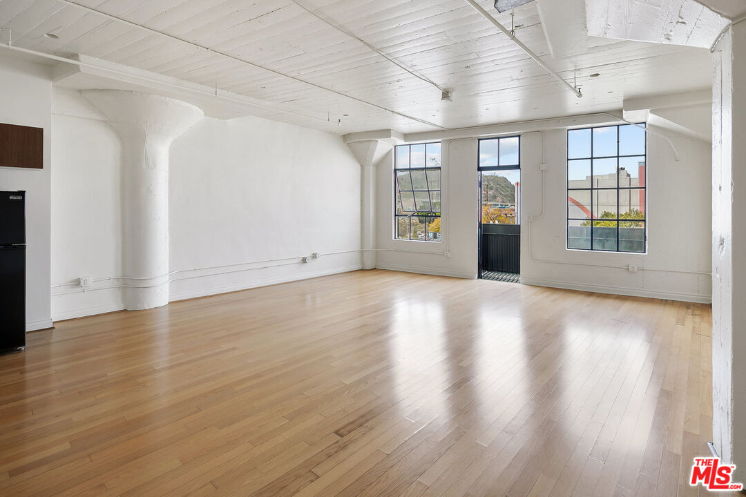 200 North San Fernando Road, Unit 320 Los Angeles, CA 90031 - Photo 13 of 20 an empty room with wooden floor and windows