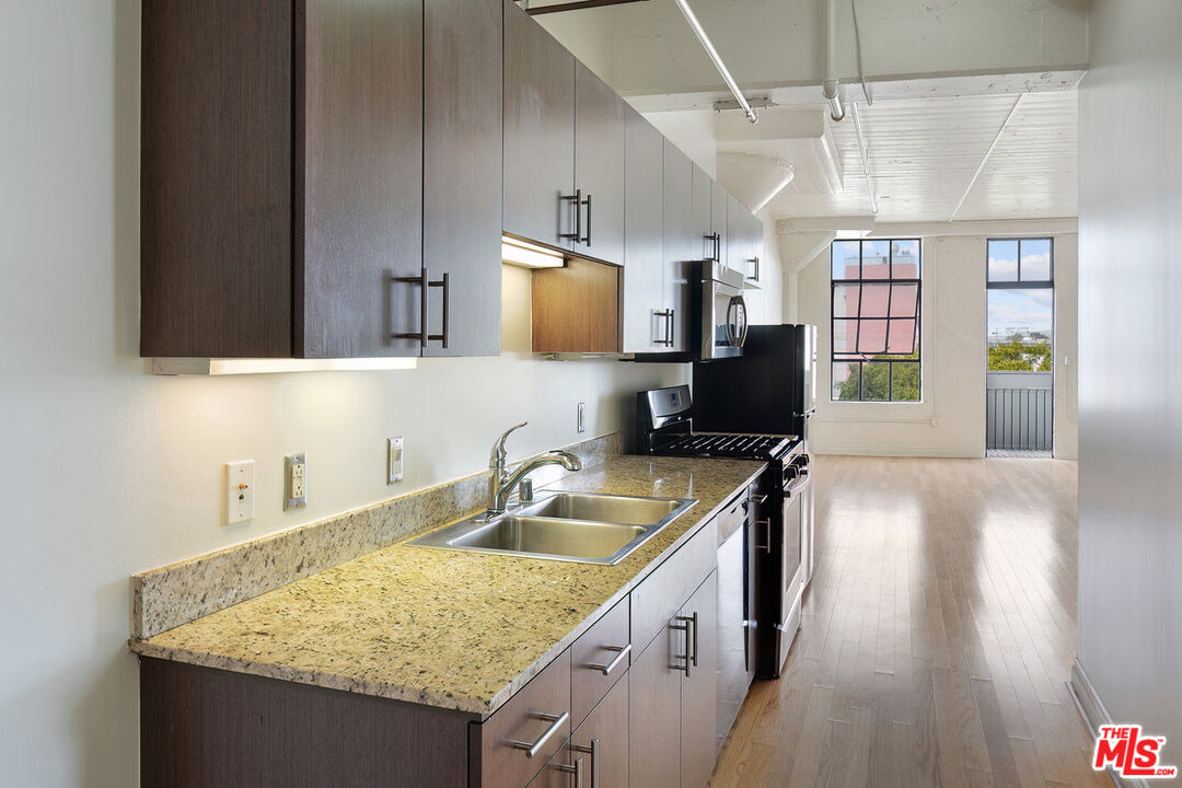 200 North San Fernando Road, Unit 320 Los Angeles, CA 90031 - Photo 9 of 20 a kitchen with a sink stove and cabinets