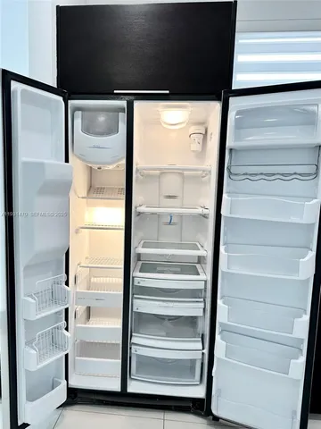 a kitchen with stainless steel appliances a refrigerator and stove