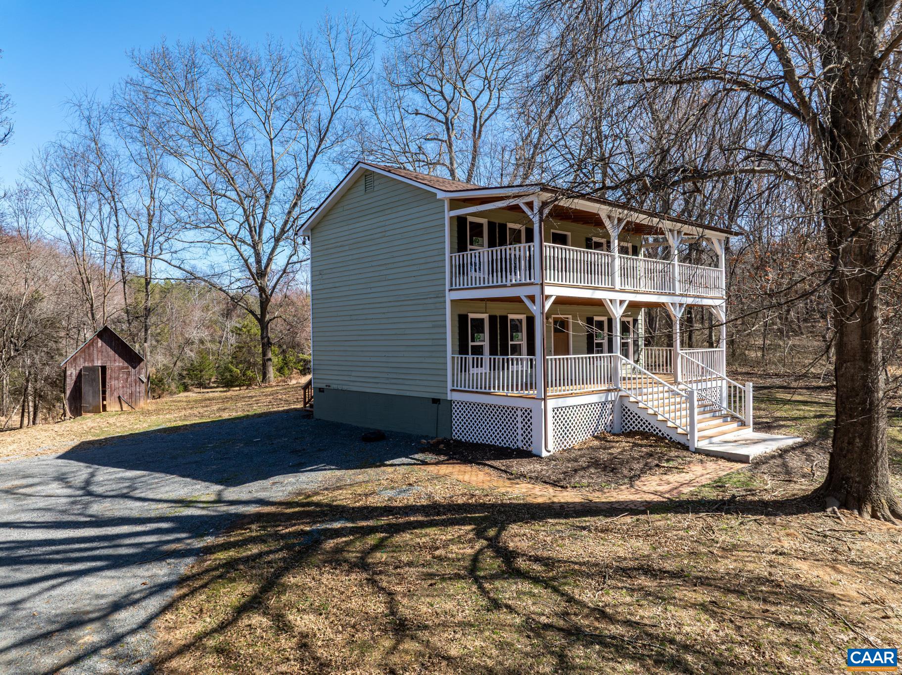 13259 Stonehouse Mountain Road Culpeper, VA 22701 - Photo 2 of 31 a house with trees in the background