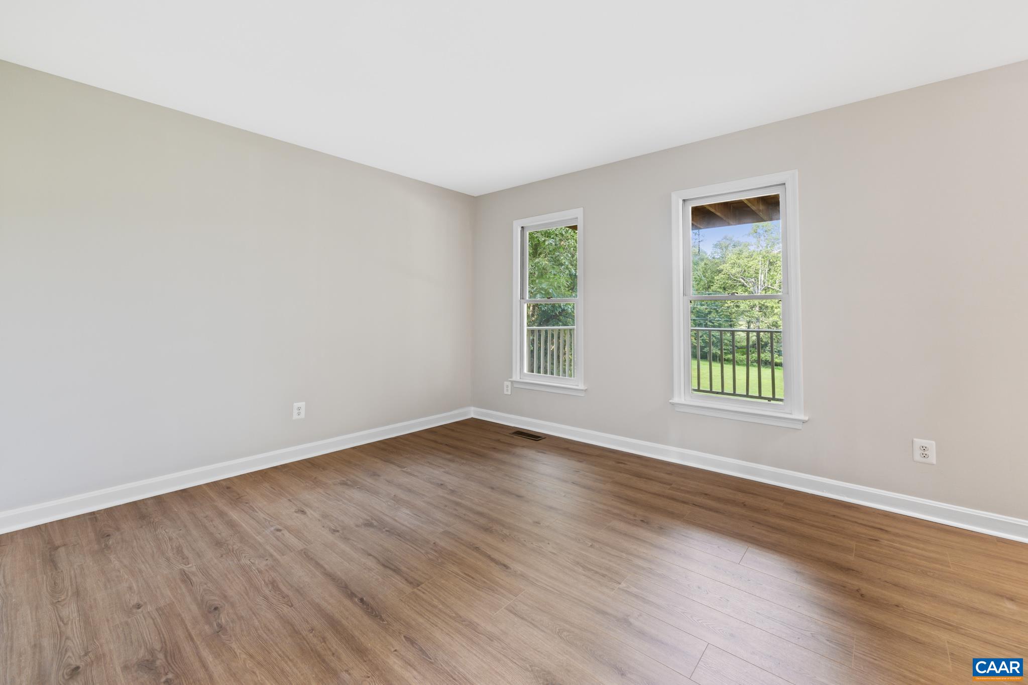 13259 Stonehouse Mountain Road Culpeper, VA 22701 - Photo 7 of 31 an empty room with wooden floor and windows