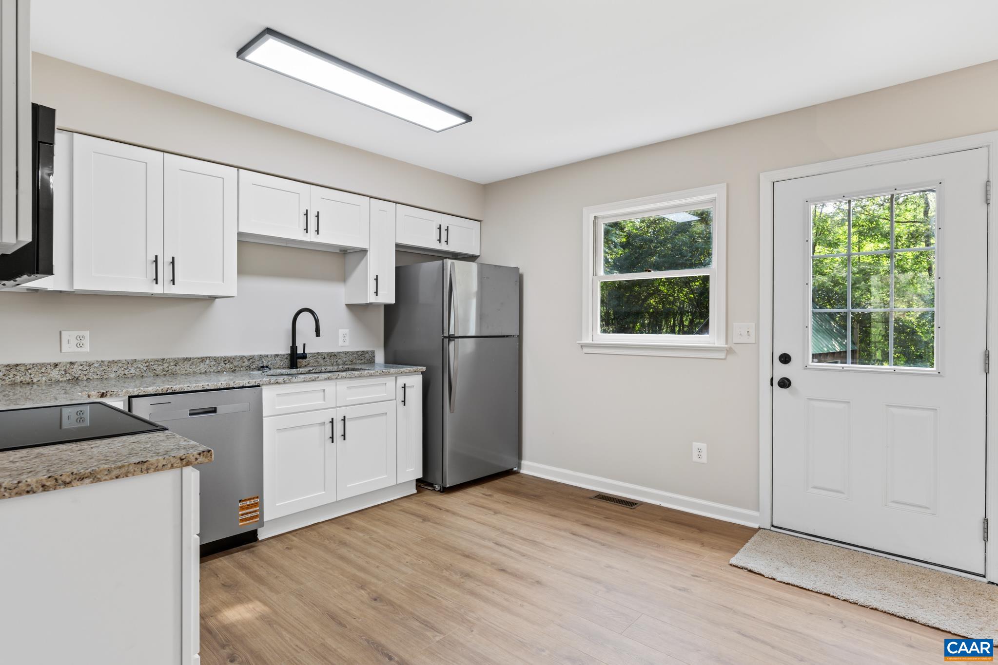 13259 Stonehouse Mountain Road Culpeper, VA 22701 - Photo 10 of 31 a kitchen with granite countertop white cabinets and white appliances