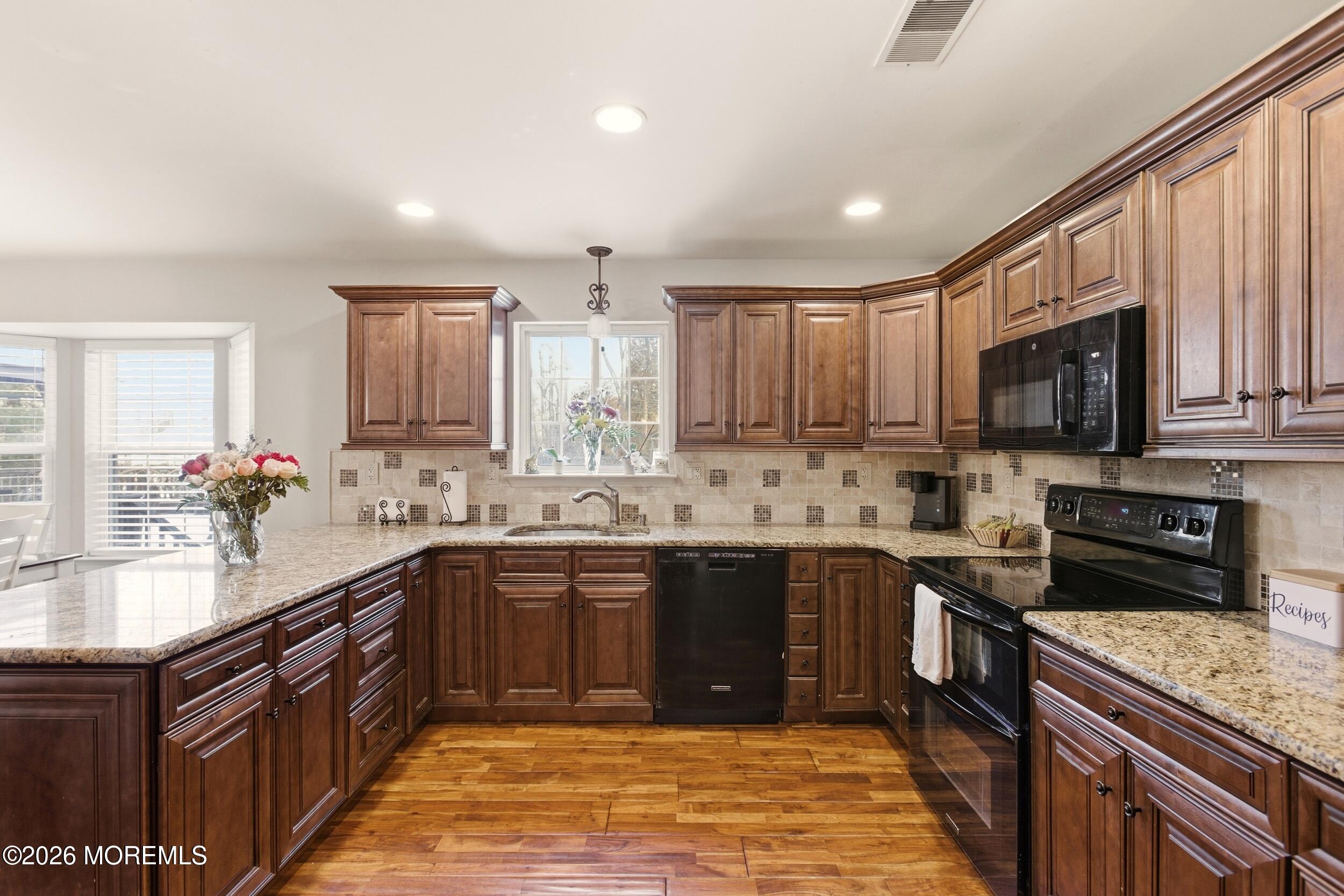 3 Arrowhead Circle Jackson, NJ 08527 - Photo 12 of 34 a large kitchen with stainless steel appliances granite countertop a sink stove and microwave