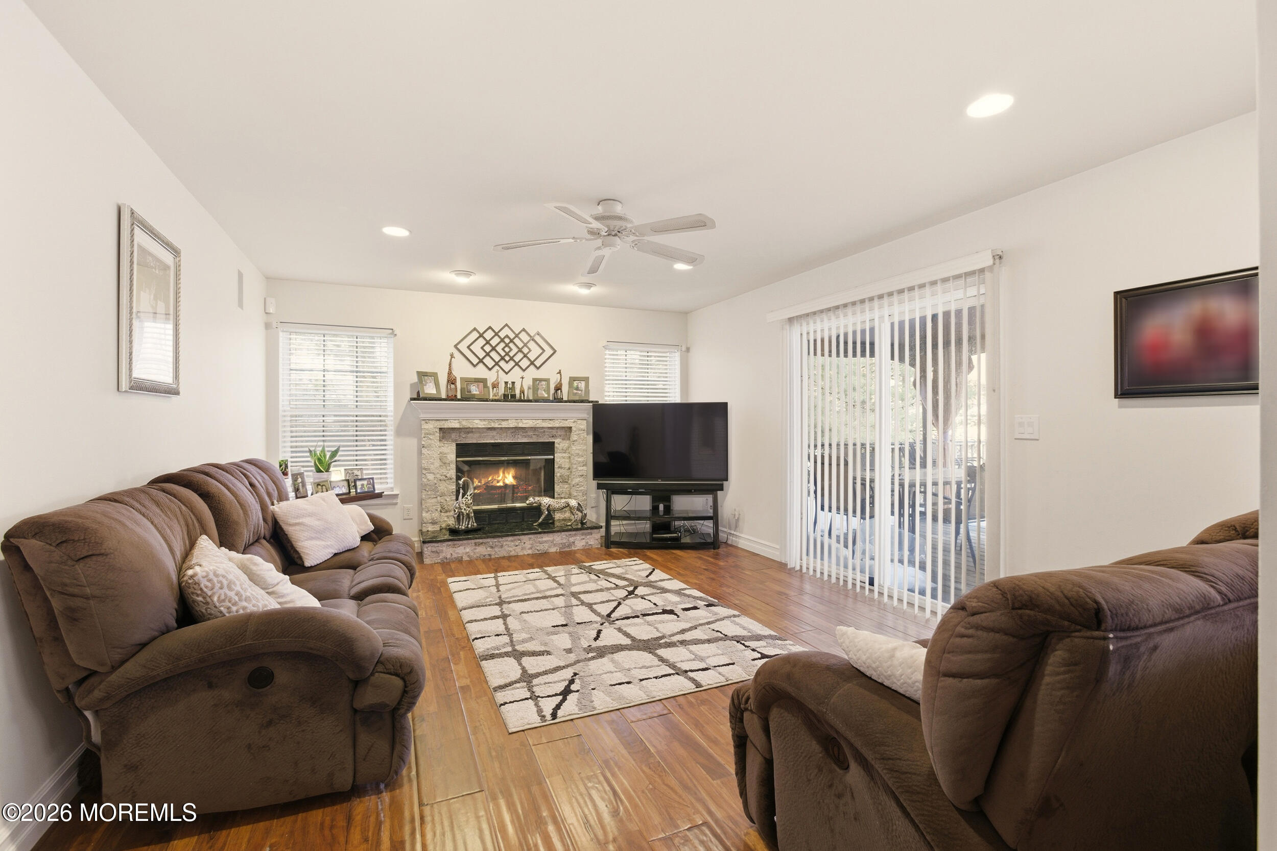 3 Arrowhead Circle Jackson, NJ 08527 - Photo 16 of 34 a living room with furniture a flat screen tv and a fireplace