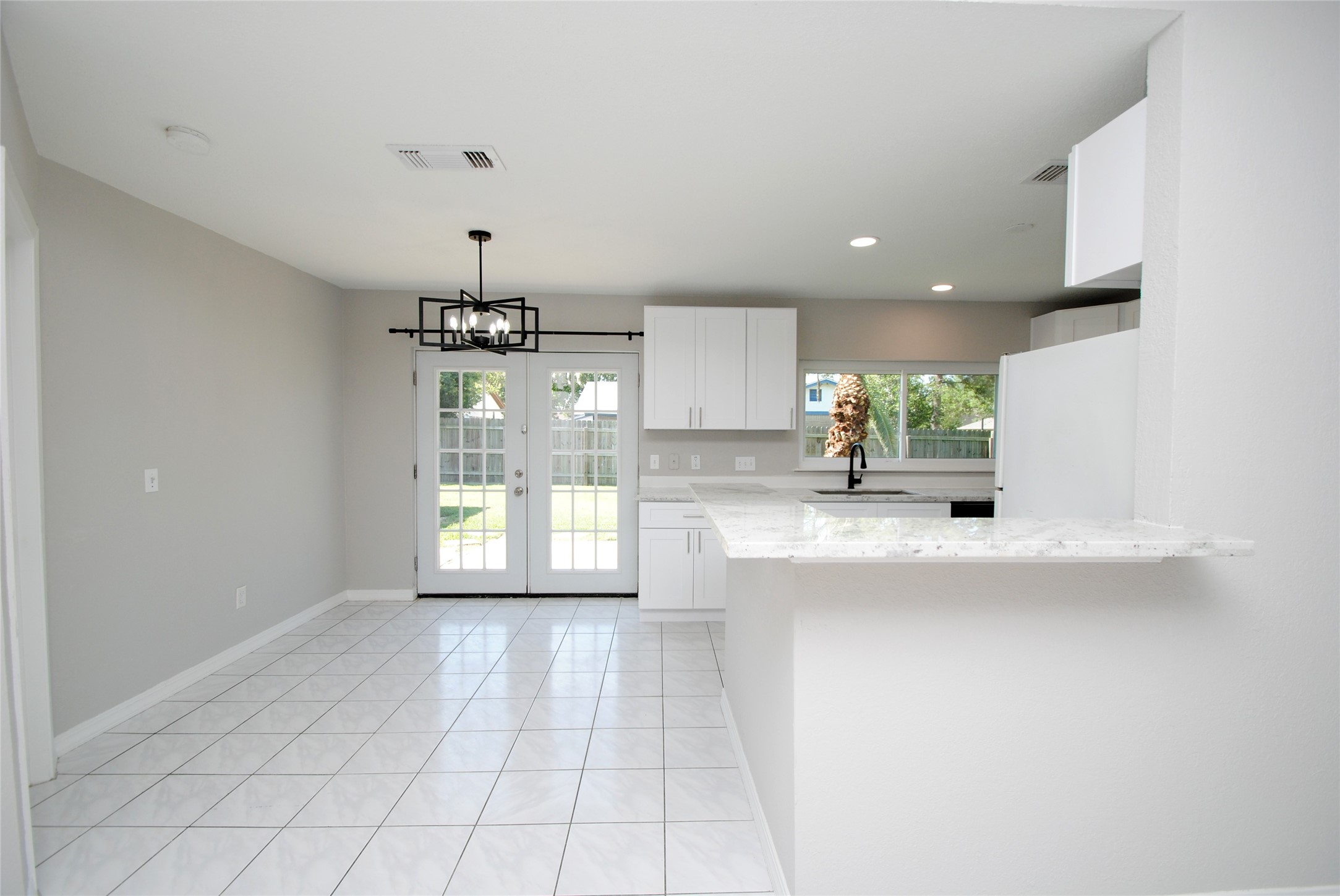 22831 John Rolfe Lane Katy, TX 77449 - Photo 10 of 34 a large kitchen with granite countertop a sink window and cabinets