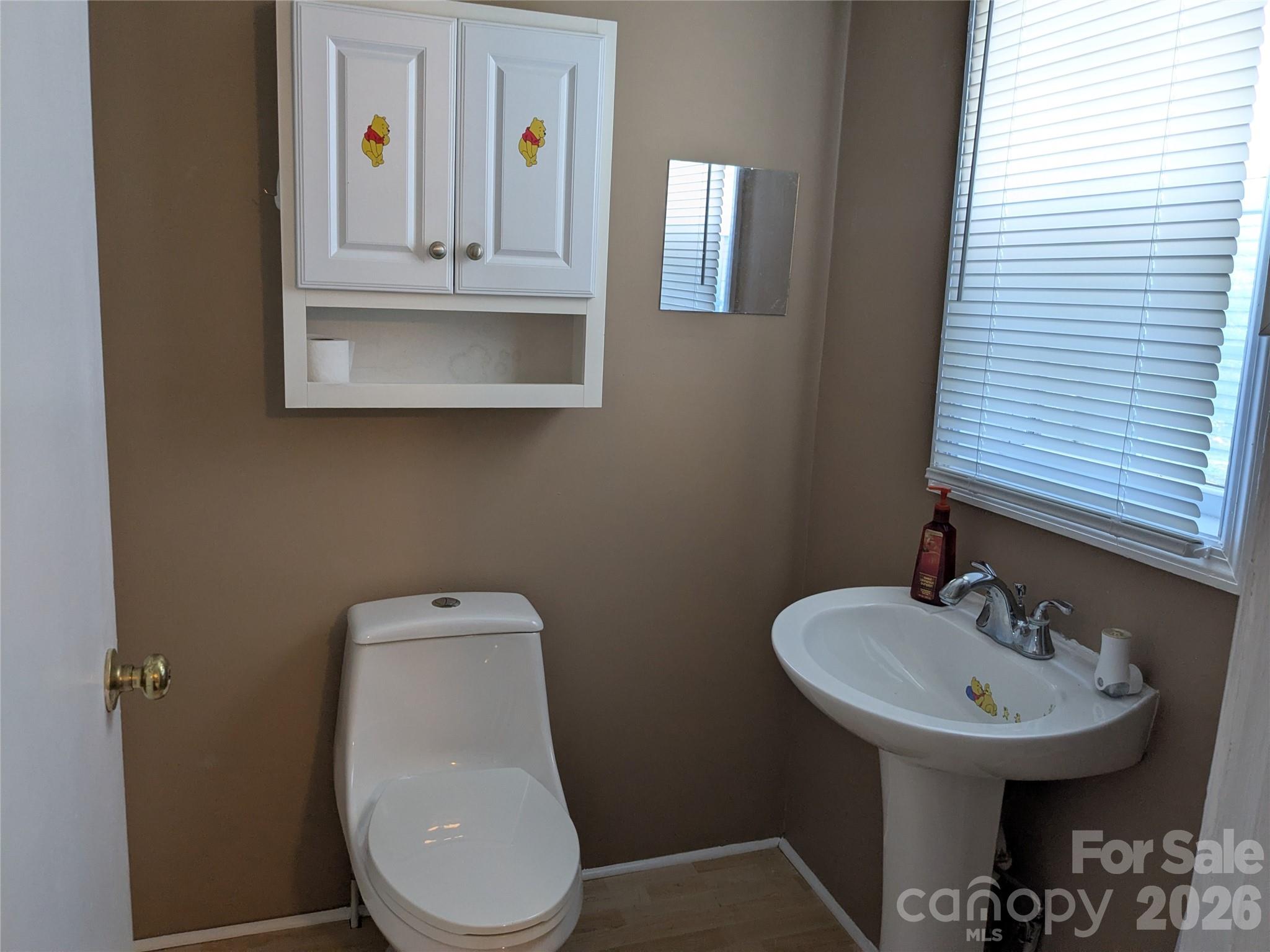 207 Morris Street Kings Mountain, NC 28086 - Photo 7 of 9 a bathroom with a toilet sink and mirror