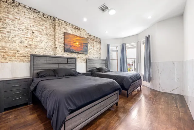 a bedroom with a bed and a night stand