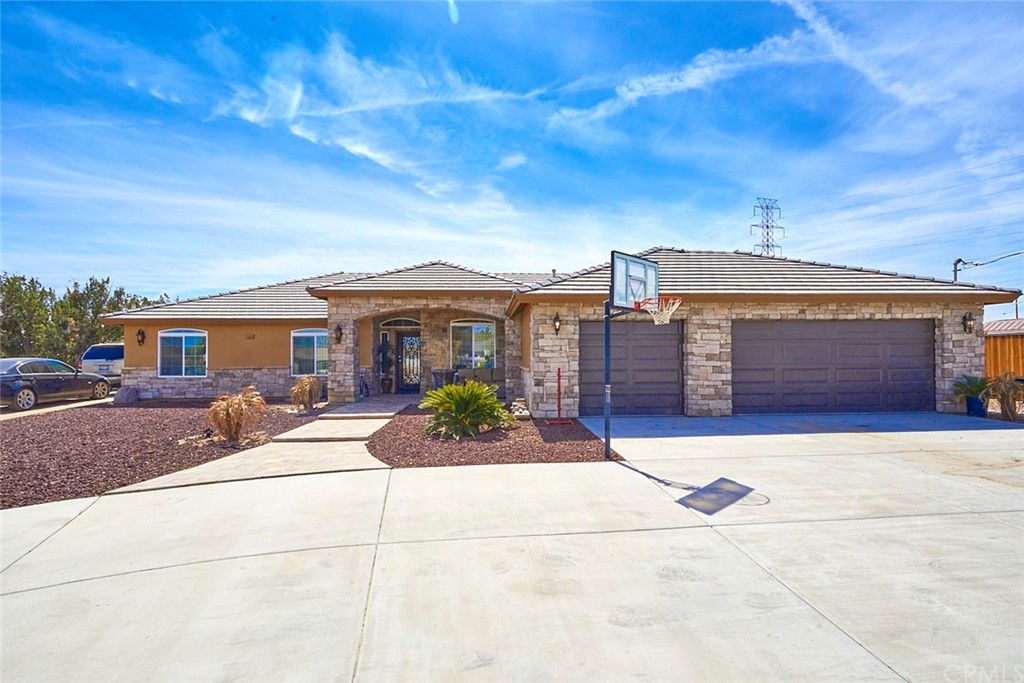 14555 Ranchero Road Hesperia, CA 92345 - Photo 1 of 1 a front view of a house with a yard and garage