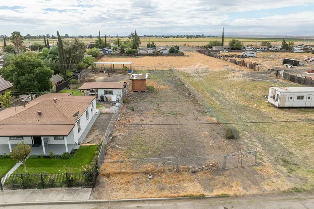 a view of a terrace with lawn chairs
