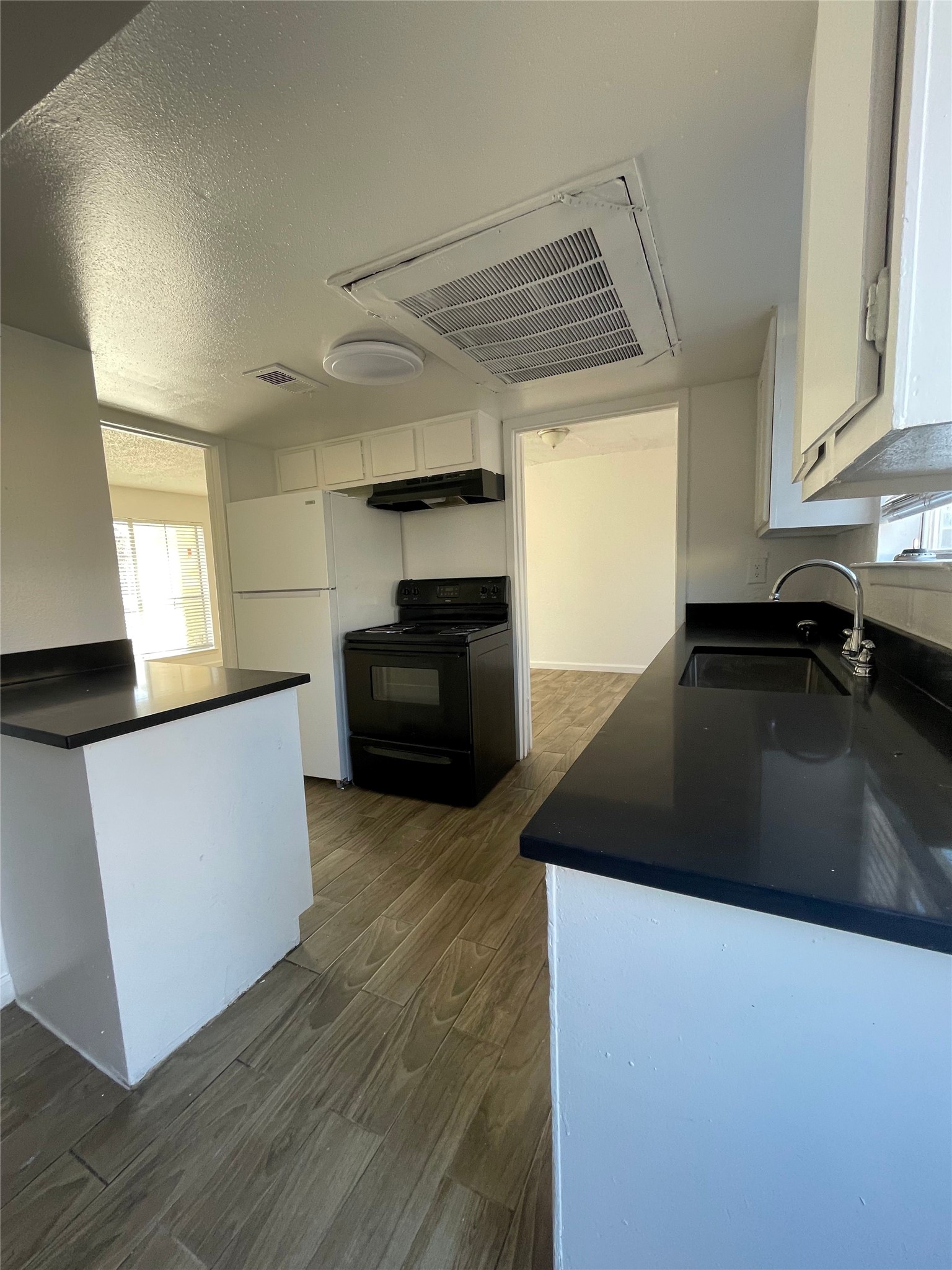 6200 West Tidwell Road, Unit 2102 Houston, TX 77092 - Photo 5 of 14 a kitchen with granite countertop a sink and a stove top oven