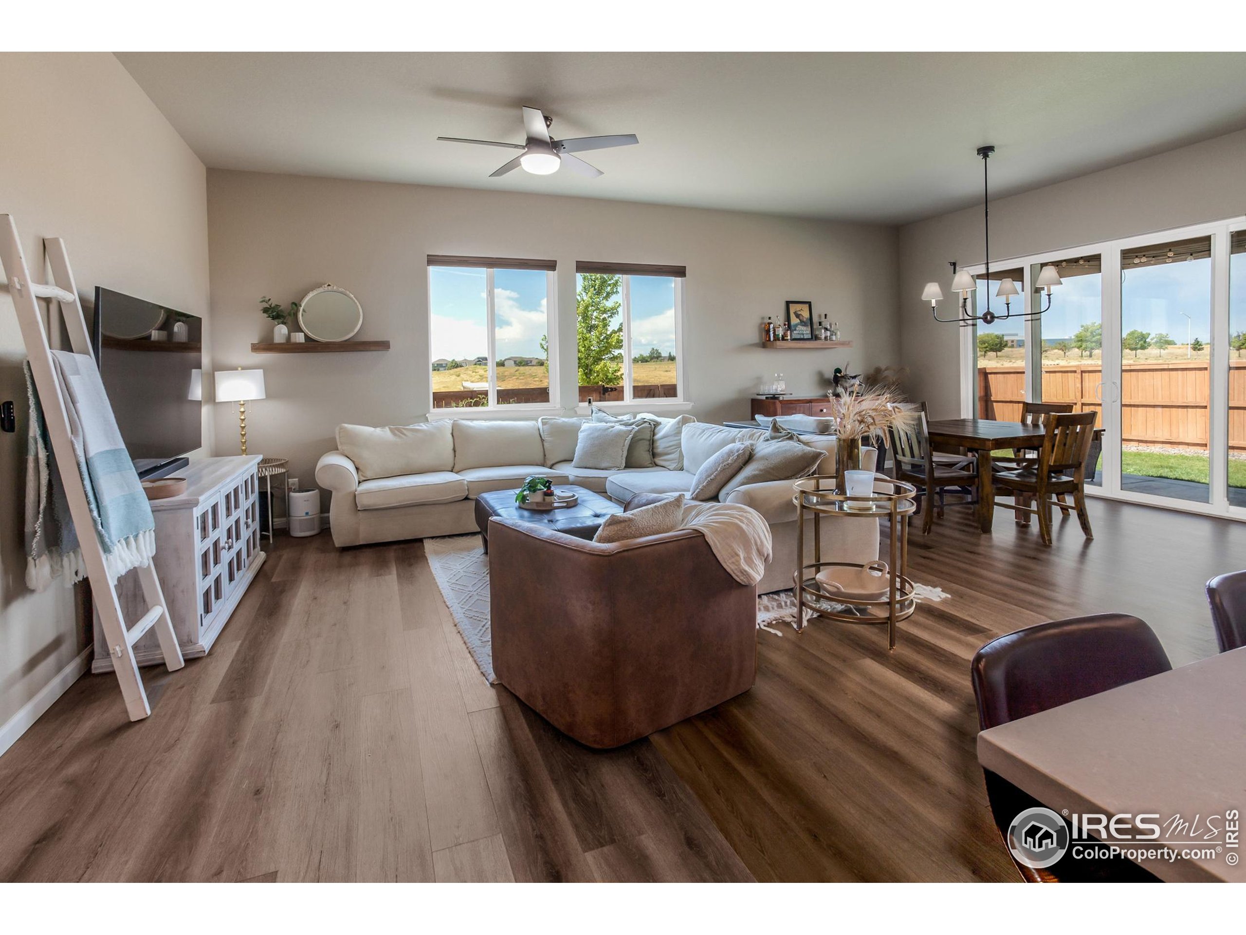 1231 105th Avenue Greeley, CO 80634 - Photo 12 of 43 a living room with furniture and a wooden floor