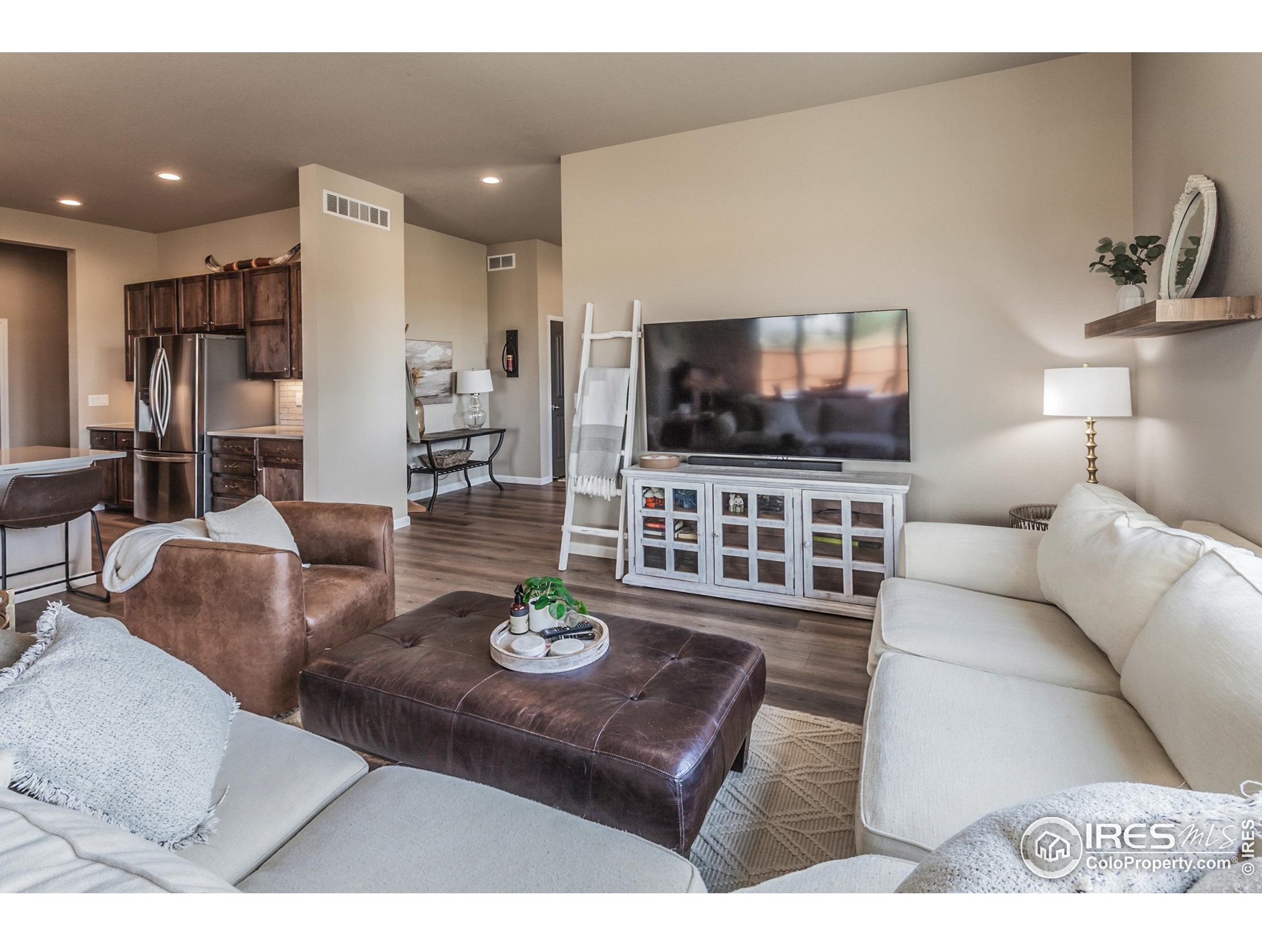 1231 105th Avenue Greeley, CO 80634 - Photo 13 of 43 a living room with furniture and a flat screen tv