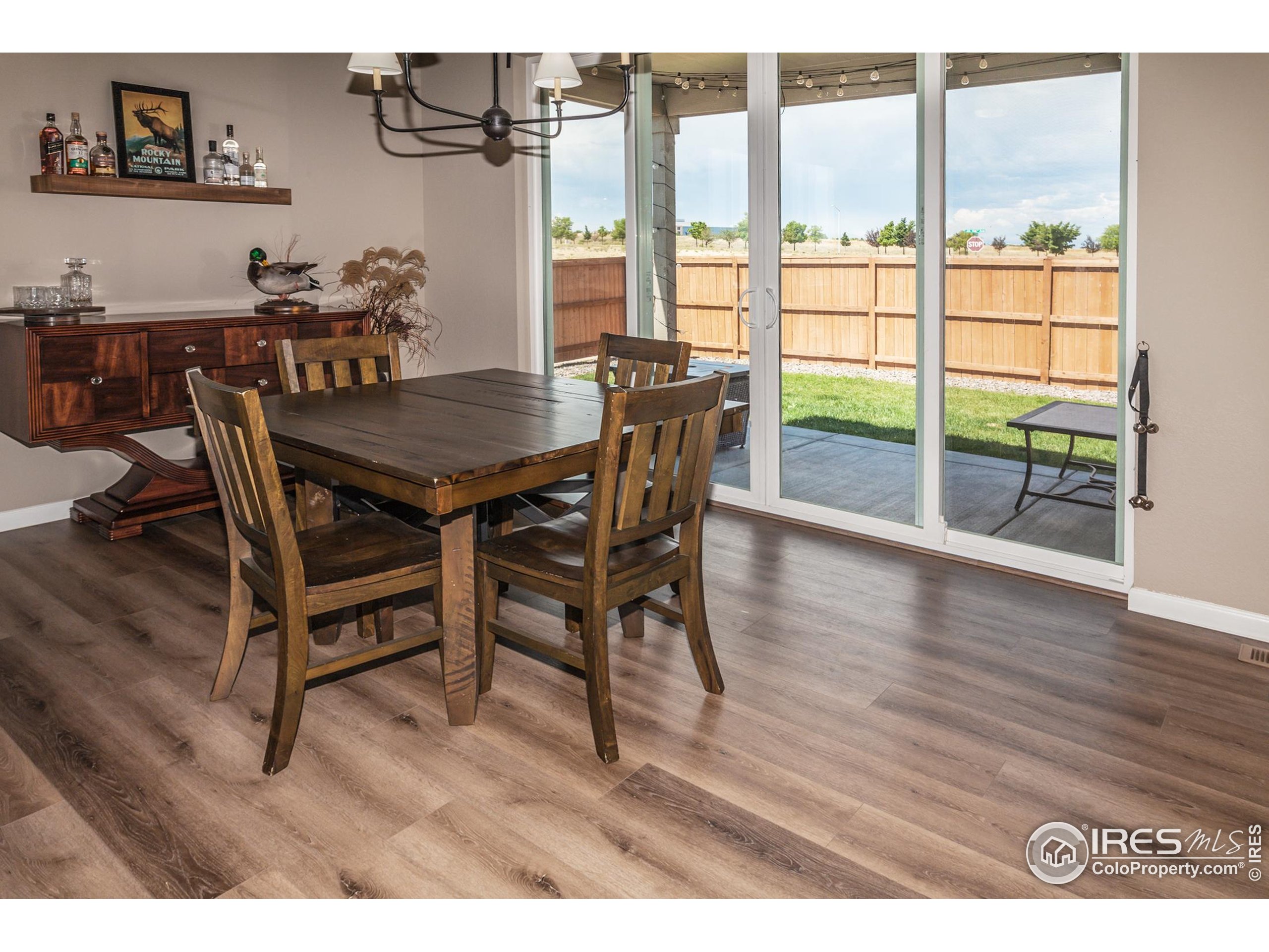 1231 105th Avenue Greeley, CO 80634 - Photo 16 of 43 a view of a dining room with furniture window and wooden floor