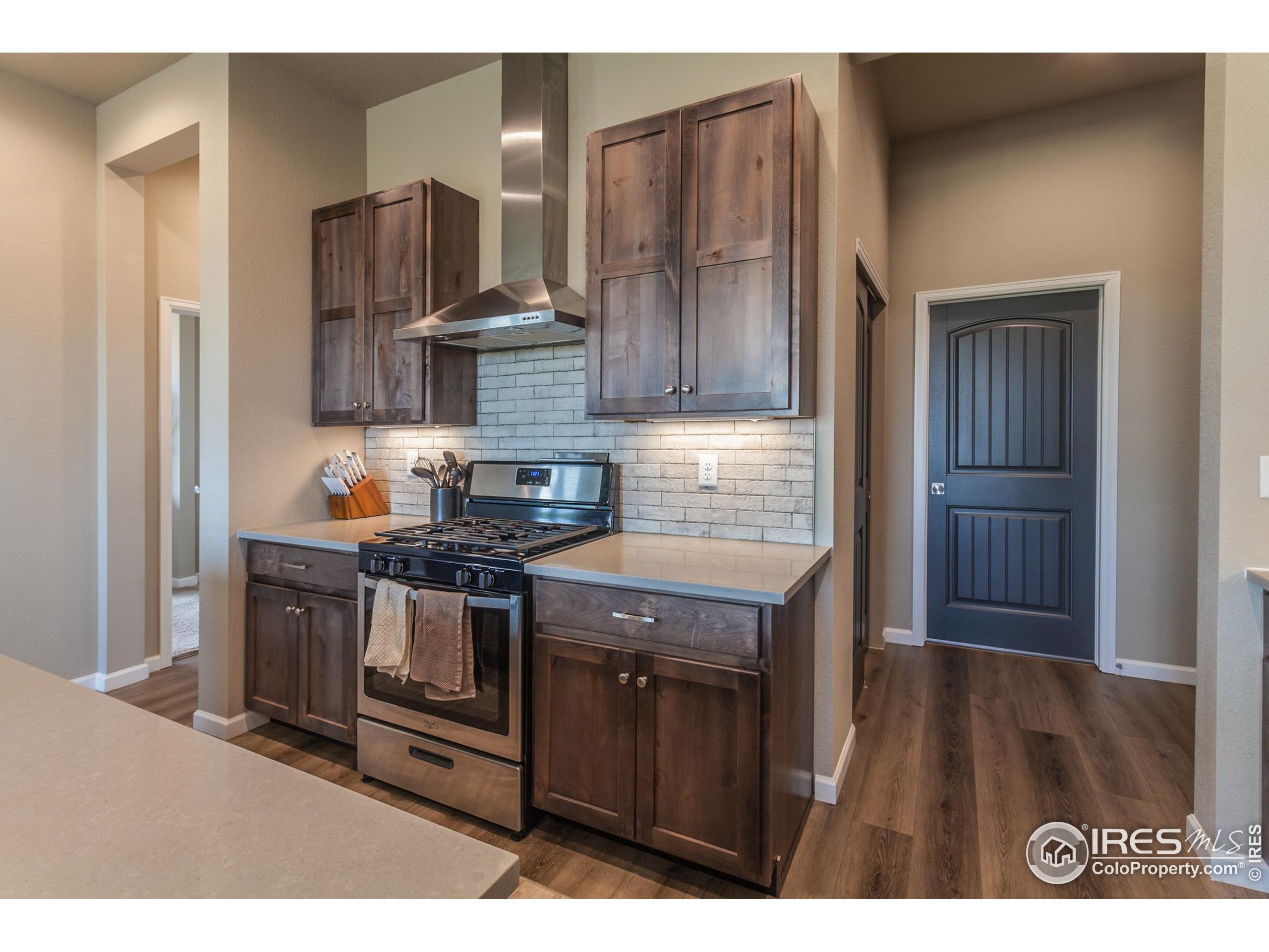 1231 105th Avenue Greeley, CO 80634 - Photo 20 of 43 a kitchen with stainless steel appliances granite countertop a stove a sink and a refrigerator