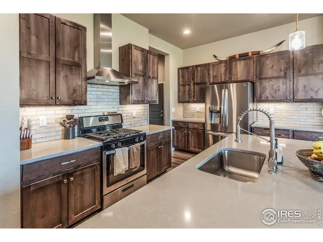 a kitchen with granite countertop a sink and a stove