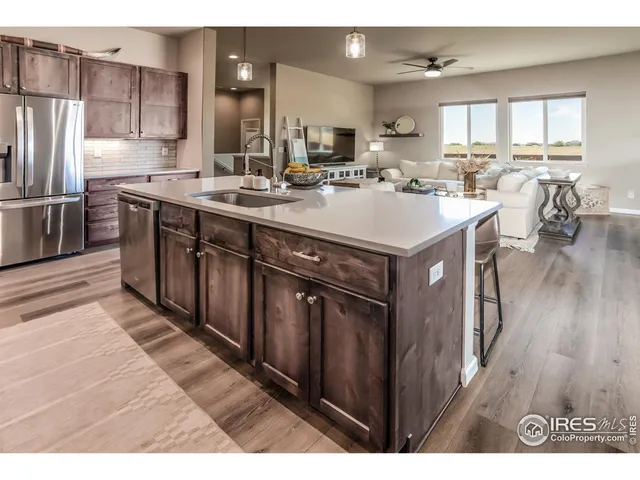 a kitchen with kitchen island a sink appliances and cabinets