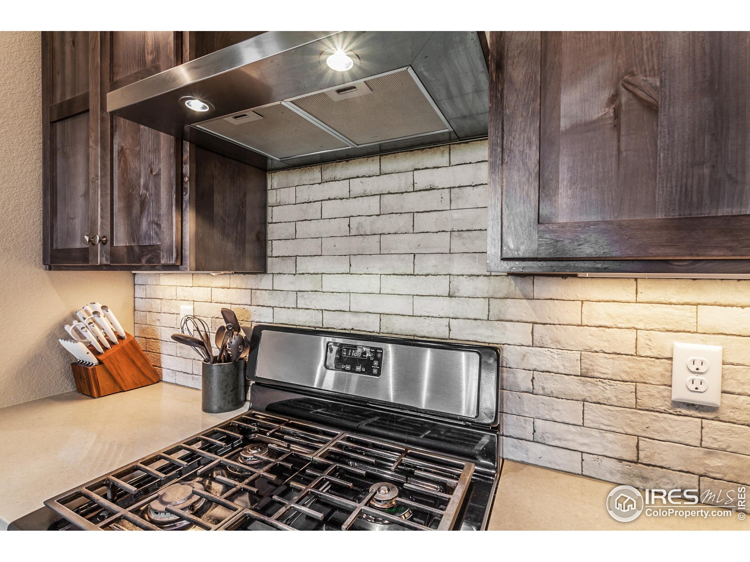 1231 105th Avenue Greeley, CO 80634 - Photo 23 of 43 a kitchen with a stove and cabinets