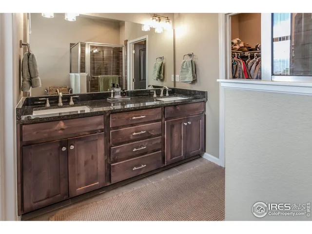 a bathroom with a double vanity sink and two mirror