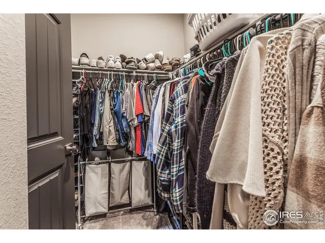 a view of walk in closet with clothes