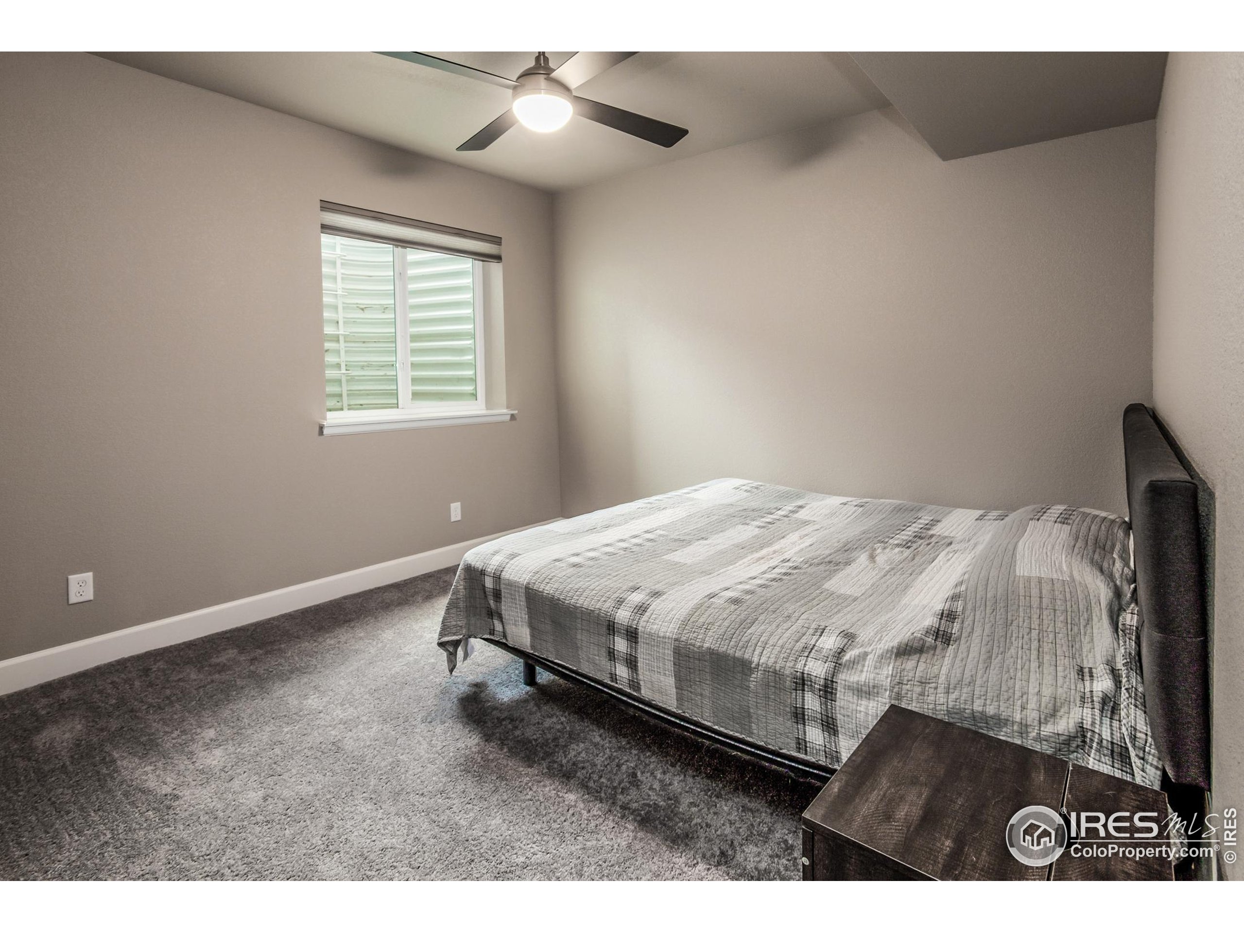 1231 105th Avenue Greeley, CO 80634 - Photo 34 of 43 a bed sitting in a bedroom next to a window