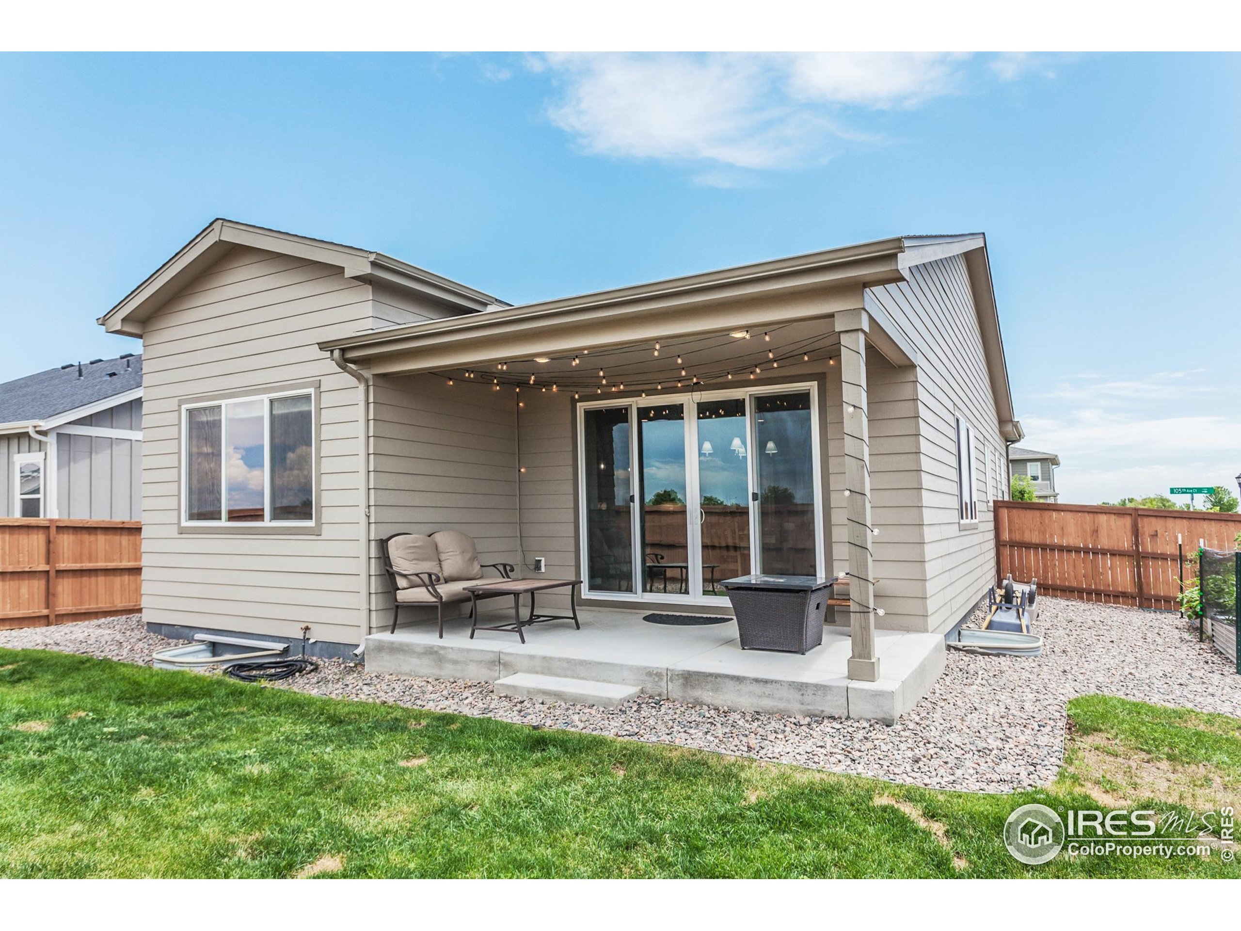 1231 105th Avenue Greeley, CO 80634 - Photo 42 of 43 a backyard of a house with table and chairs