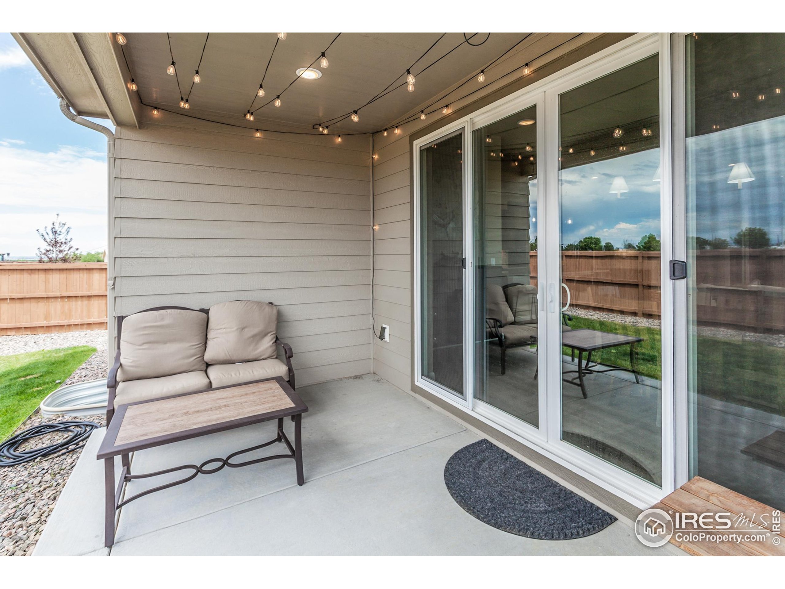 1231 105th Avenue Greeley, CO 80634 - Photo 43 of 43 a outdoor living space with furniture and a rug