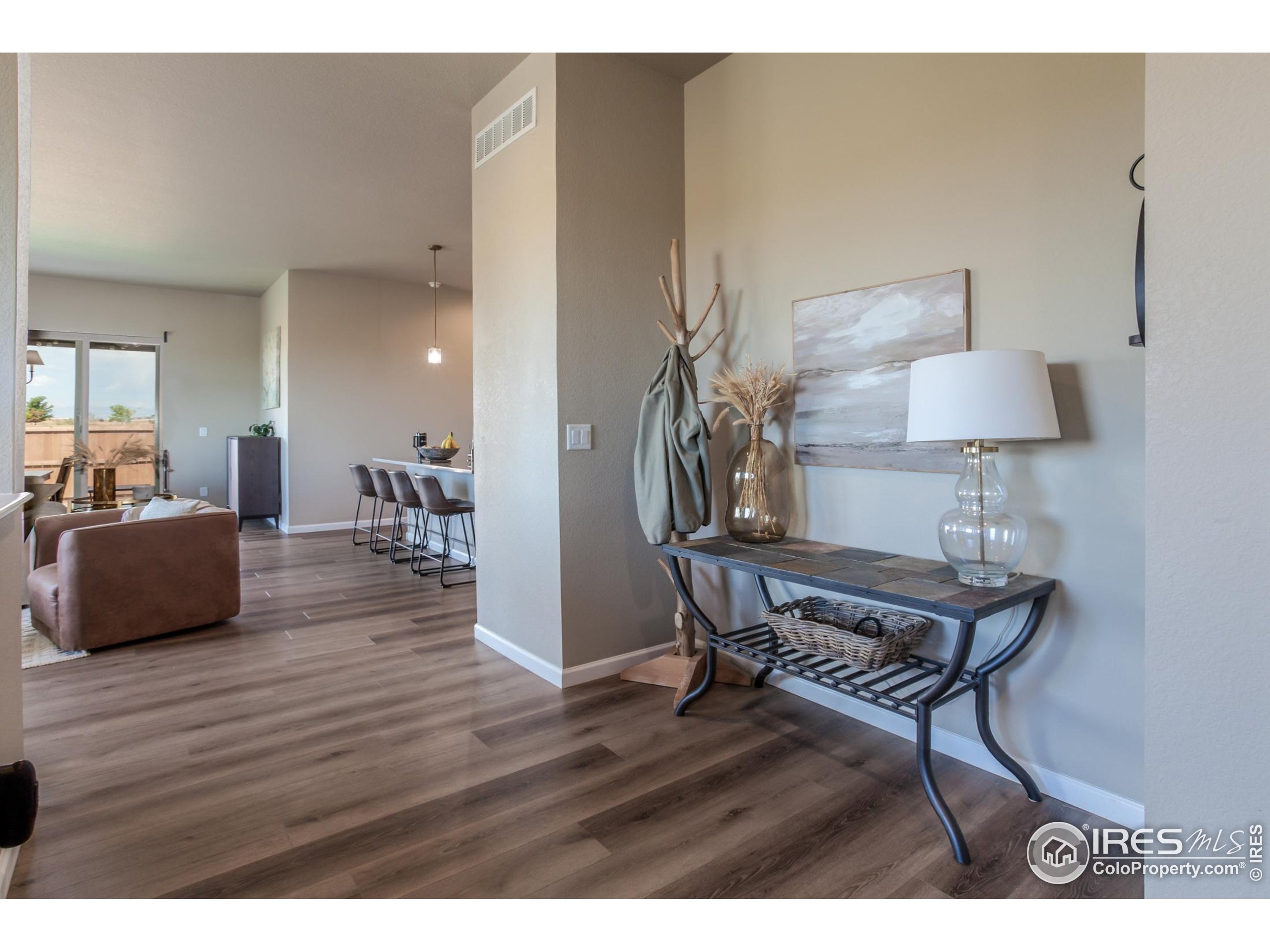 1231 105th Avenue Greeley, CO 80634 - Photo 8 of 43 a living room with furniture and a wooden floor