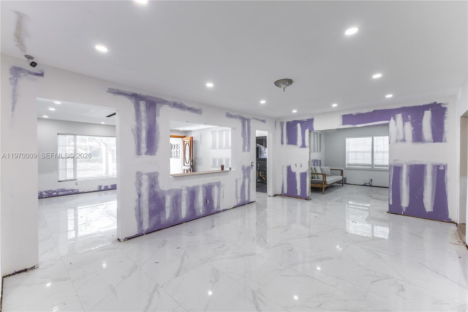 4555 Alton Road Miami Beach, FL 33140 - Photo 11 of 34 a view of a hall with refrigerator and kitchen