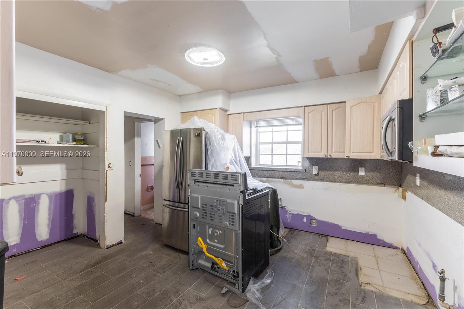 4555 Alton Road Miami Beach, FL 33140 - Photo 14 of 34 a spacious bathroom with stainless steel appliances granite countertop a refrigerator and a sink