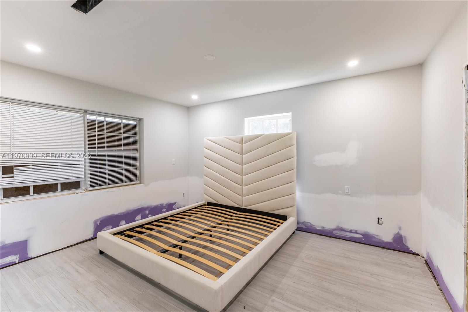 4555 Alton Road Miami Beach, FL 33140 - Photo 15 of 34 a view of room with stairs and wooden floor