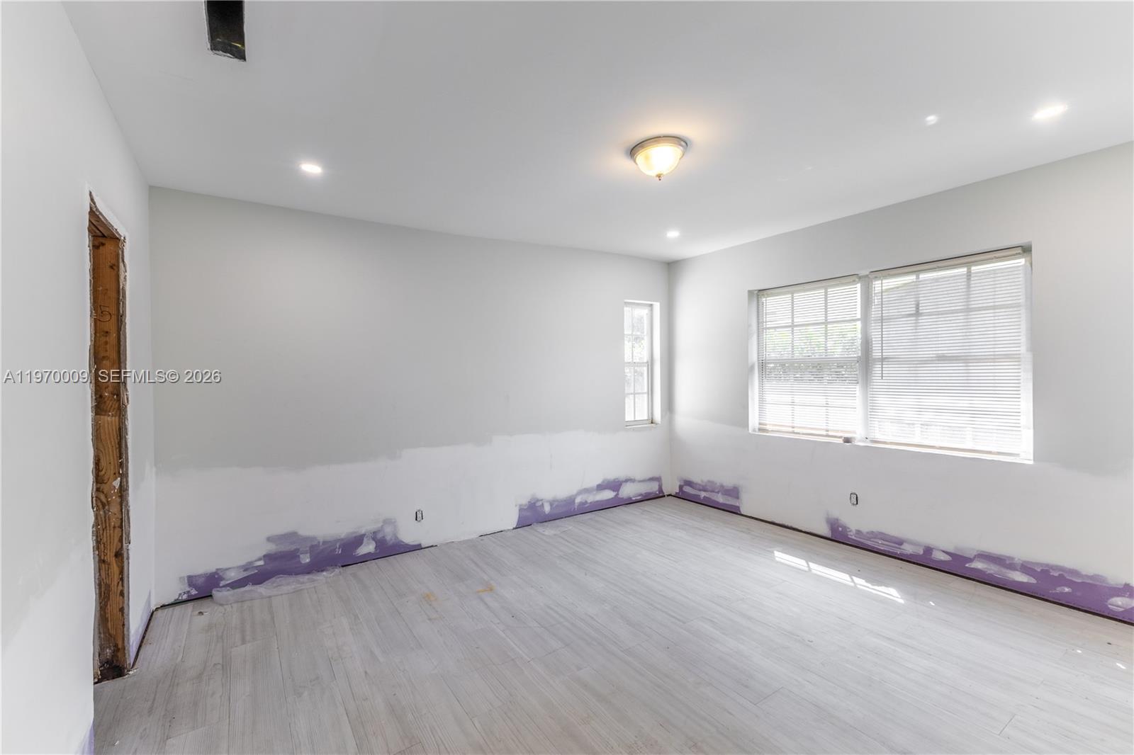 4555 Alton Road Miami Beach, FL 33140 - Photo 17 of 34 an empty room with windows and closet