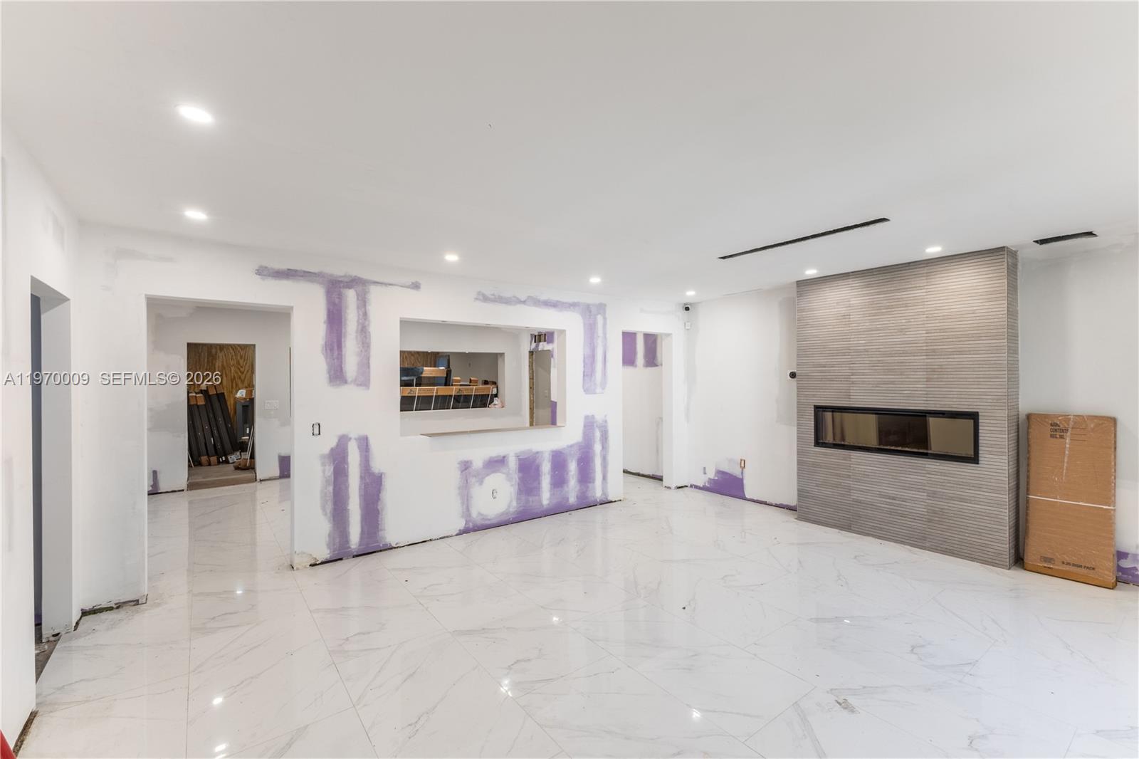 4555 Alton Road Miami Beach, FL 33140 - Photo 8 of 34 a living room with furniture and a flat screen tv