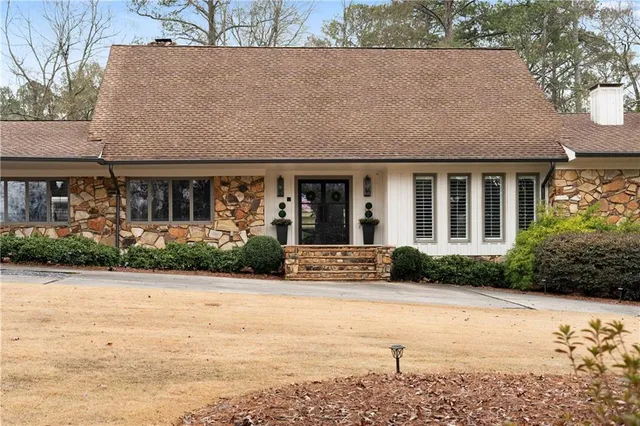 a front view of house with yard and green space