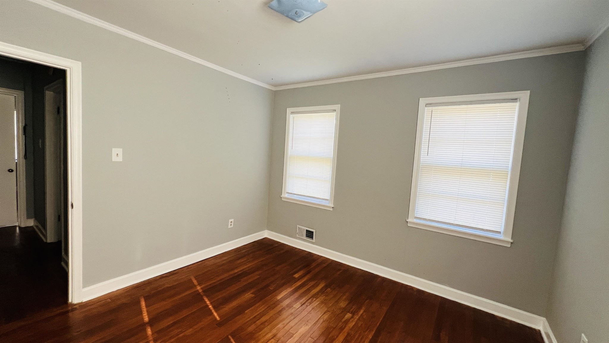 3579 Powell Avenue Memphis, TN 38122 - Photo 12 of 18 a view of an empty room with wooden floor and a window