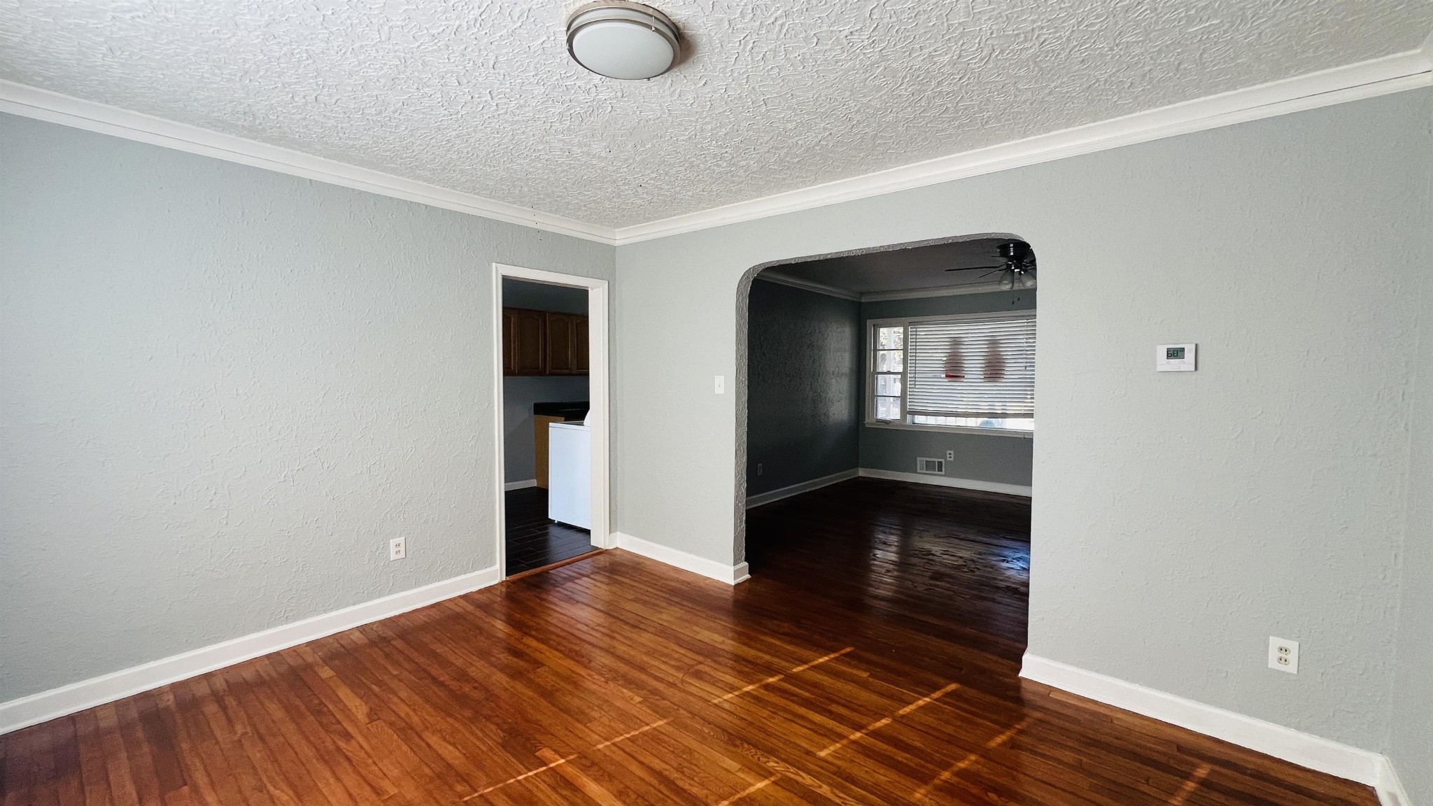 3579 Powell Avenue Memphis, TN 38122 - Photo 15 of 18 a view of an empty room with wooden floor and a window