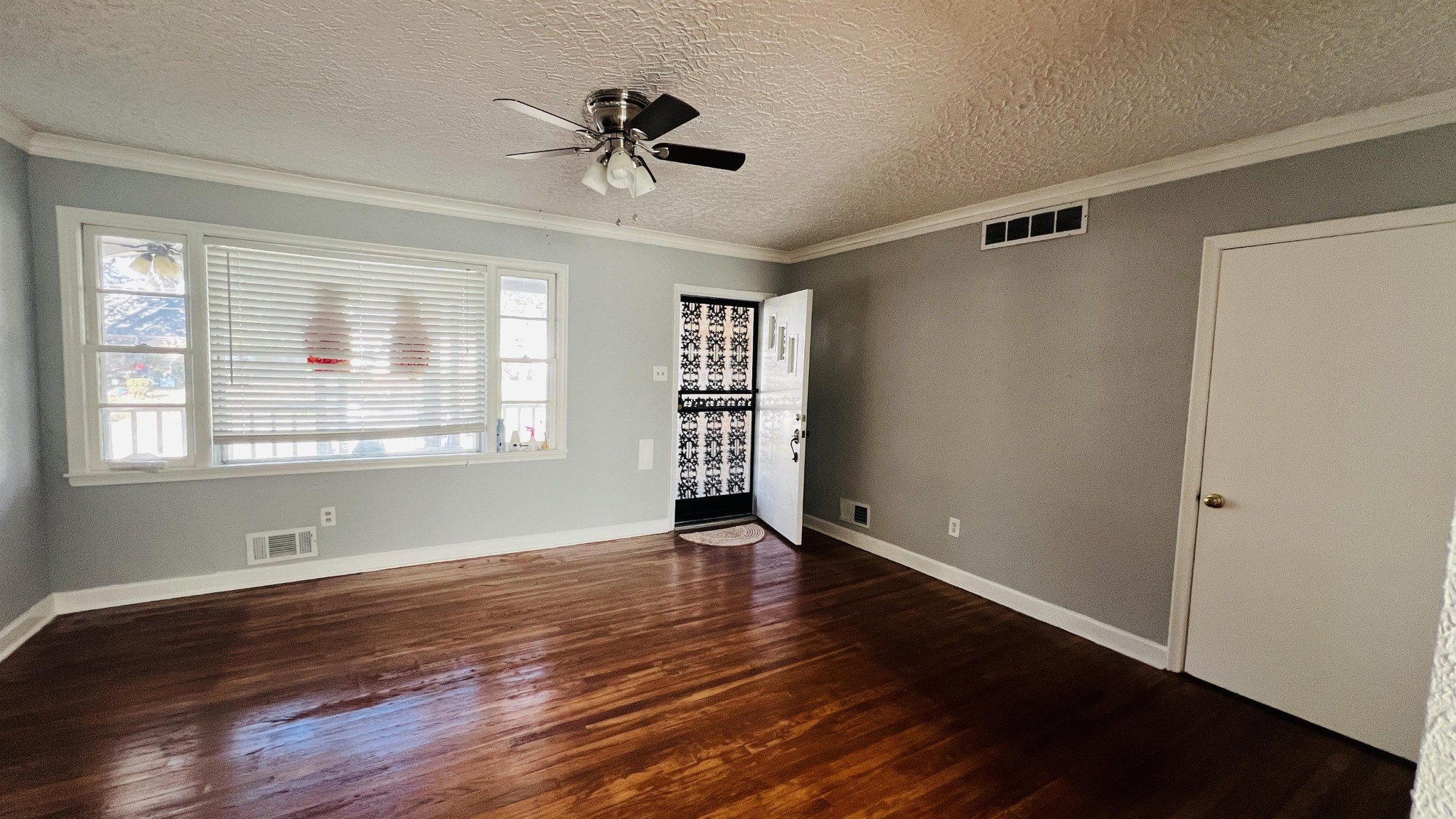 3579 Powell Avenue Memphis, TN 38122 - Photo 16 of 18 a view of an empty room with wooden floor and a window