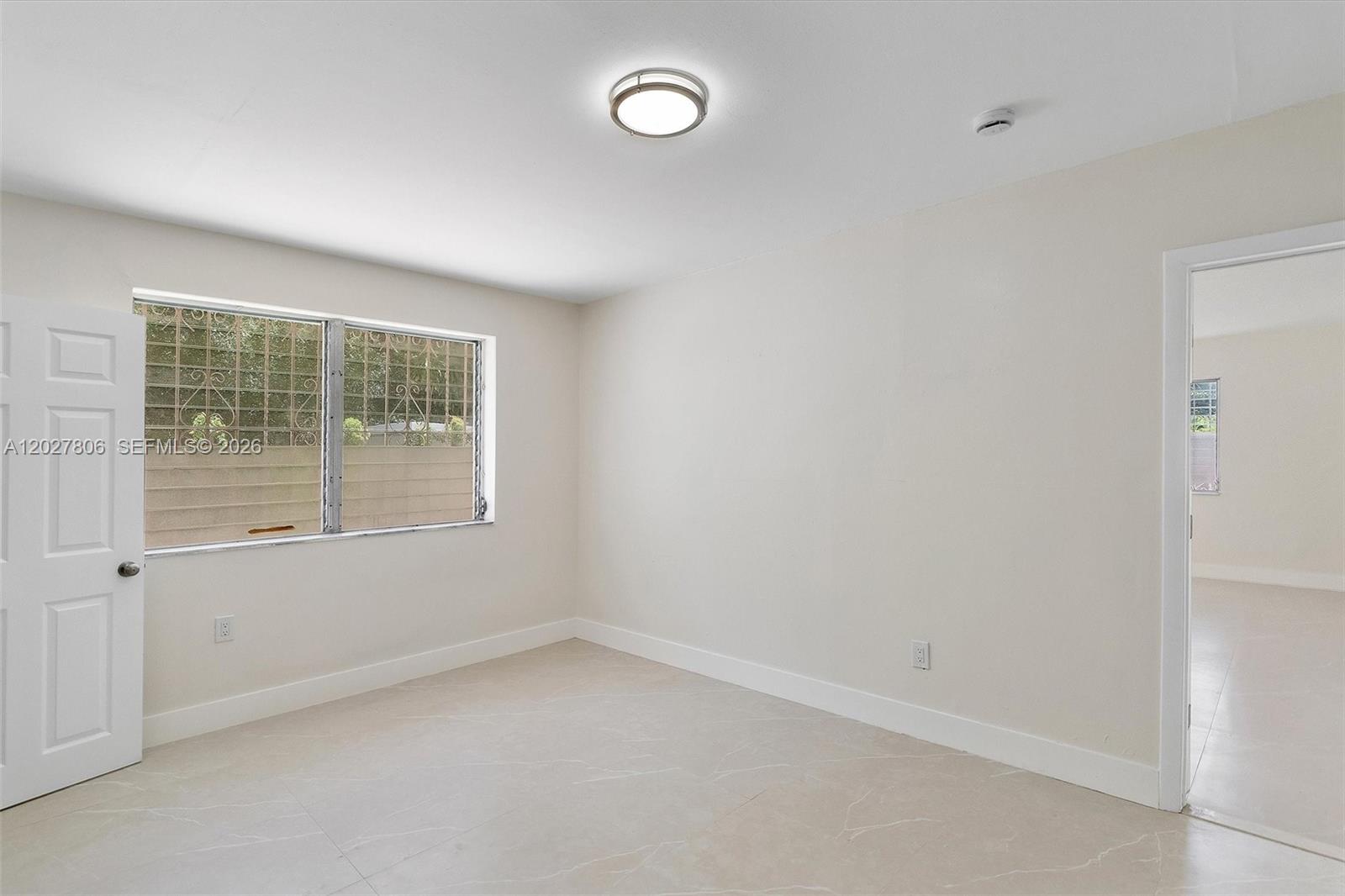 1612 Southwest 23rd Street, Unit 1612 Miami, FL 33145 - Photo 22 of 42 an empty room with a window