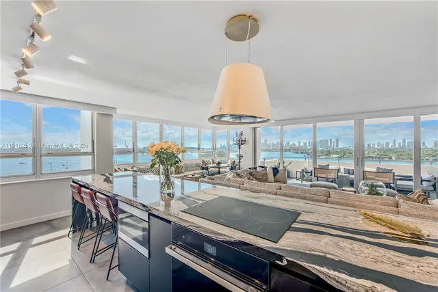 a view of a dining room with furniture water view and a large window