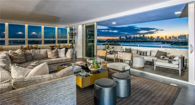a living room with furniture and a floor to ceiling window