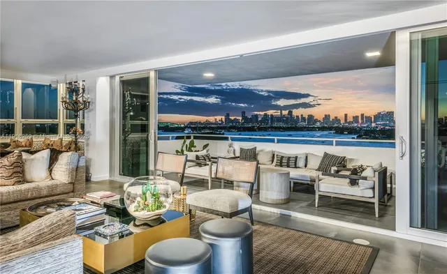a living room with furniture and a floor to ceiling window