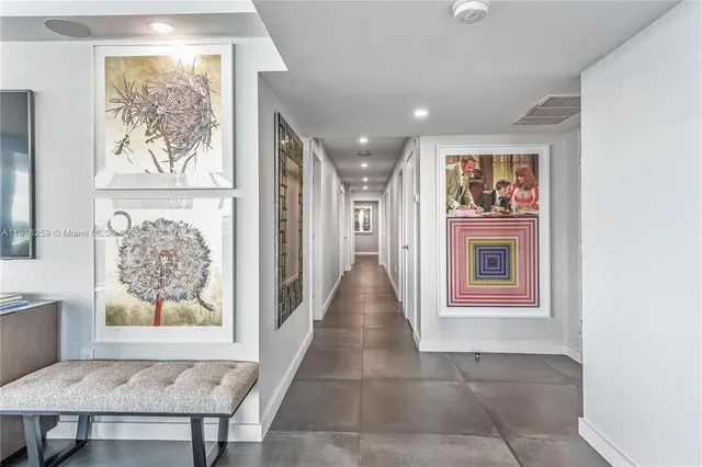 a view of a hallway with wooden floor and a workspace