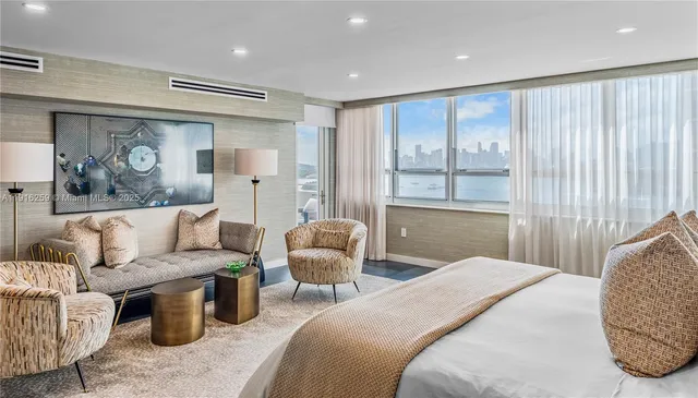 a bedroom with a large bed and a couch