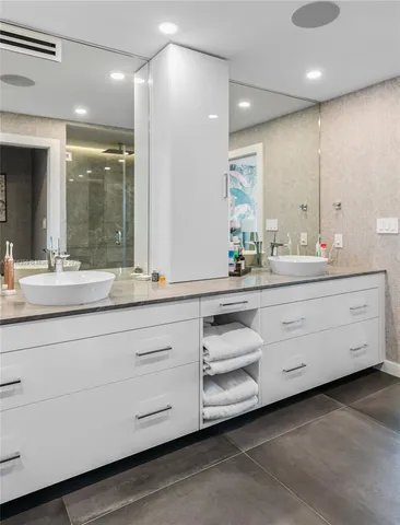 a bathroom with a double vanity sink and a mirror