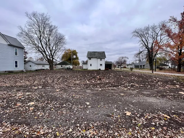 a backyard of a house with large trees