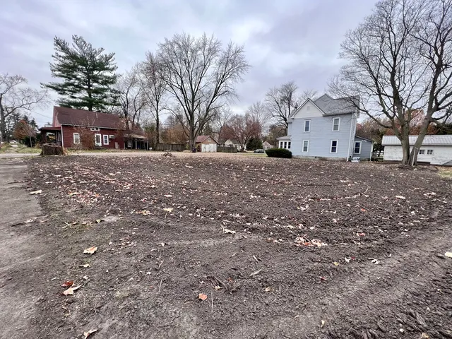a view of house with outdoor space and trees