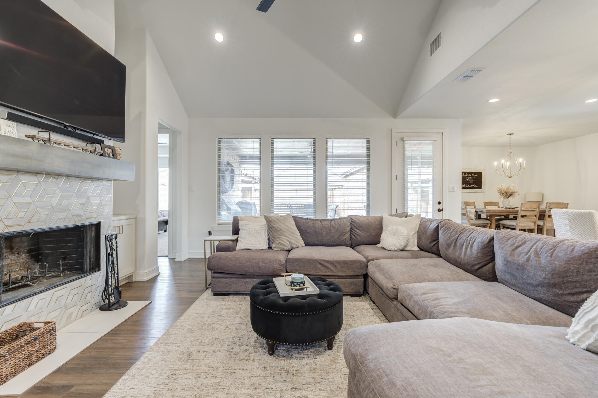 4624 139th Street Lubbock, TX 79424 - Photo 12 of 52 a living room with furniture a flat screen tv and a fireplace
