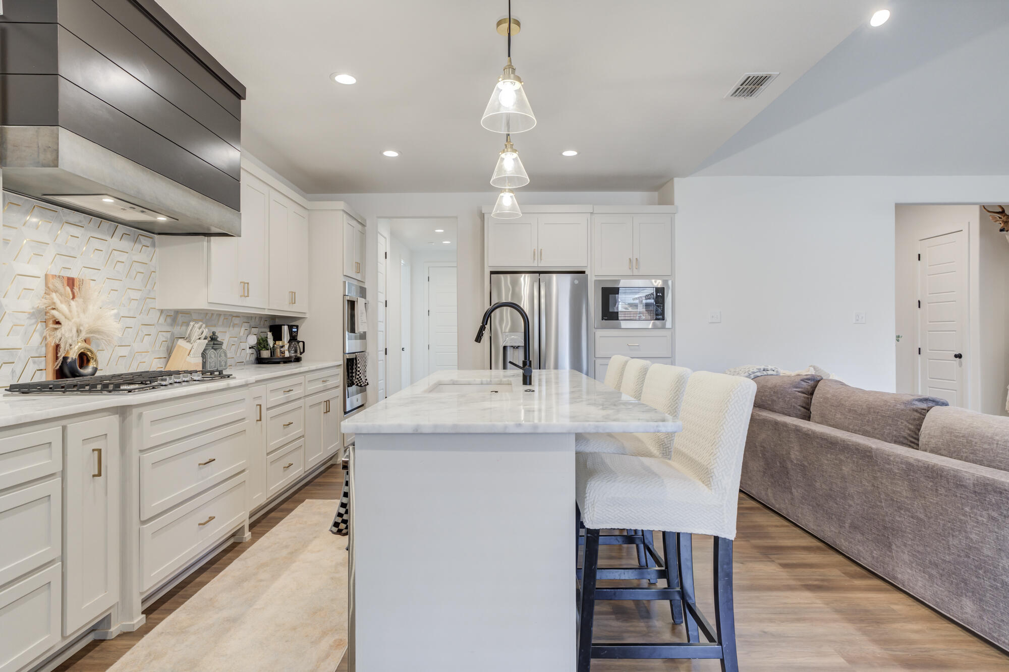 4624 139th Street Lubbock, TX 79424 - Photo 18 of 52 a kitchen with granite countertop a sink stainless steel appliances and cabinets